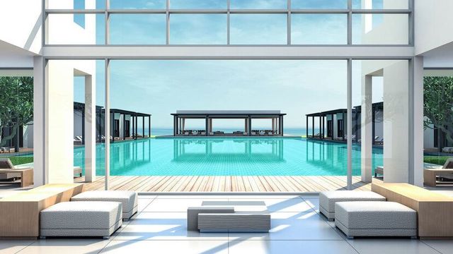 Moderner Blick auf einen Infinity-Pool im Paloma Finesse Side, eingerahmt von minimalistischer Architektur und eleganten Sonnenliegen-Pavillons mit Blick aufs Meer.